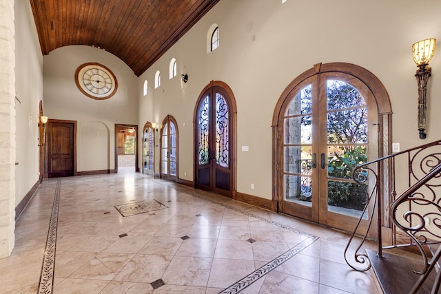 entryway with high vaulted ceiling, wood ceiling, and french doors