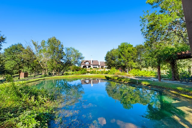 view of swimming pool with a water view