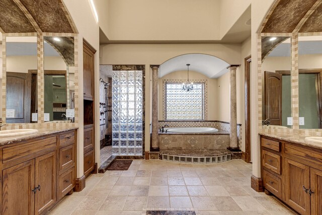4 Steven Luke Ln, Friendswood, TX 77546 - full bathroom with two vanities, a bath, decorative columns, tiled shower, and a chandelier