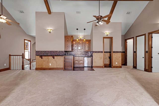 kitchen with high vaulted ceiling, ceiling fan, dark carpet, and dishwasher