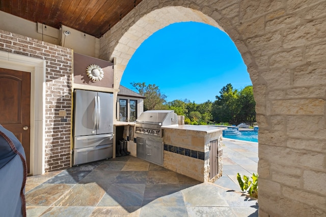 view of patio / terrace with an outdoor kitchen and a grill