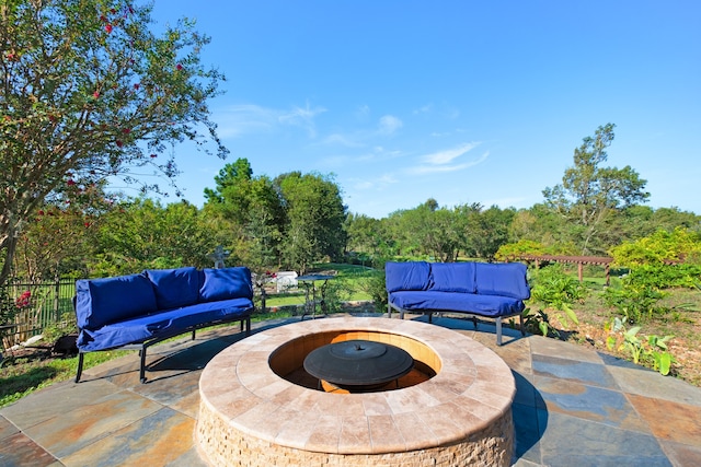 view of patio / terrace with an outdoor living space with a fire pit