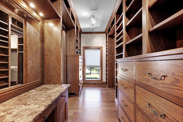 spacious closet featuring dark hardwood / wood-style flooring