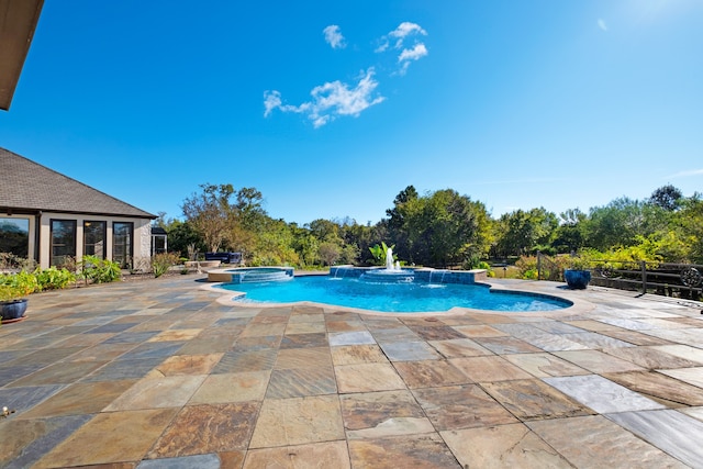 view of swimming pool featuring pool water feature, a patio, and an in ground hot tub