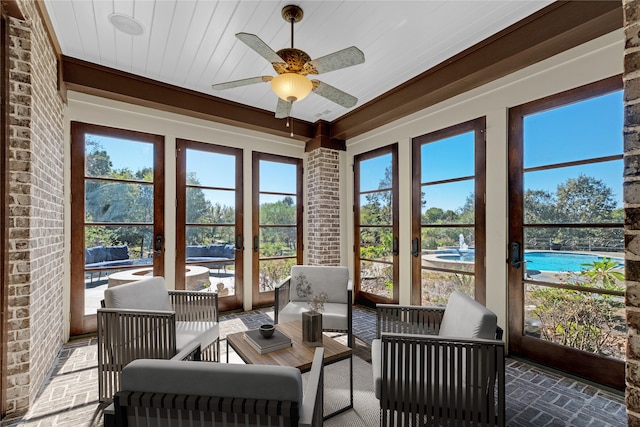 sunroom with a wealth of natural light, ceiling fan, and wooden ceiling