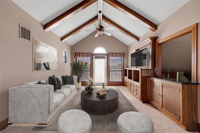 living room with lofted ceiling with beams, light carpet, and ceiling fan