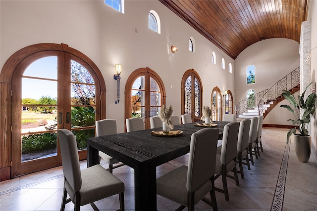 dining area with high vaulted ceiling, wood ceiling, french doors, and crown molding