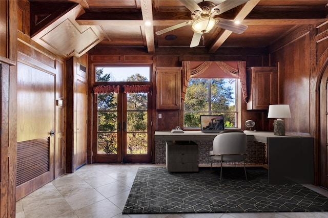 tiled home office featuring french doors, wood walls, beam ceiling, and wooden ceiling