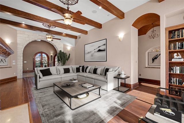 living room featuring ceiling fan, wood-type flooring, and beamed ceiling