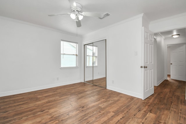 unfurnished bedroom with ornamental molding, ceiling fan, and dark hardwood / wood-style floors