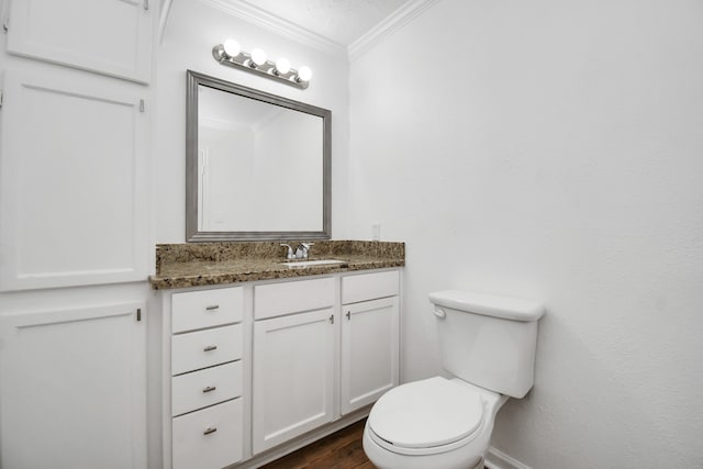 bathroom featuring hardwood / wood-style floors, vanity, toilet, and crown molding