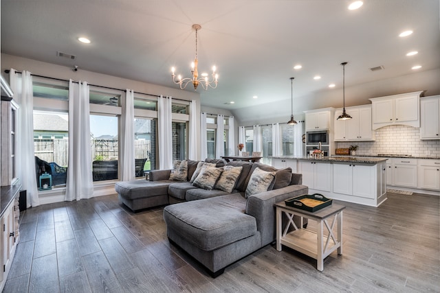 living room featuring hardwood / wood-style flooring and an inviting chandelier