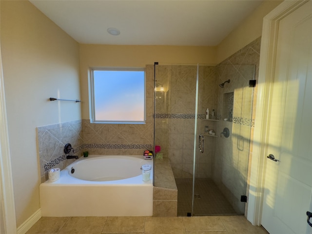 bathroom with independent shower and bath and tile patterned flooring