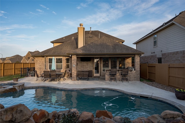 view of pool with a patio area and an in ground hot tub