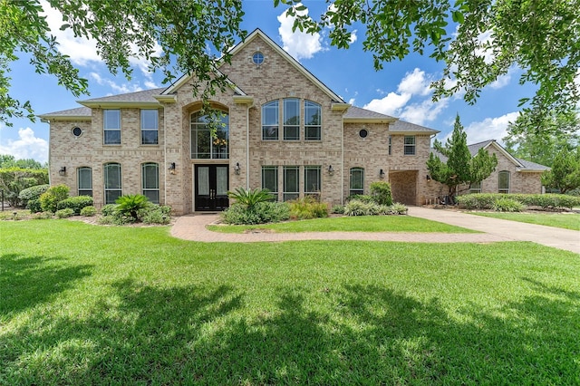 view of front of property featuring a front yard and french doors