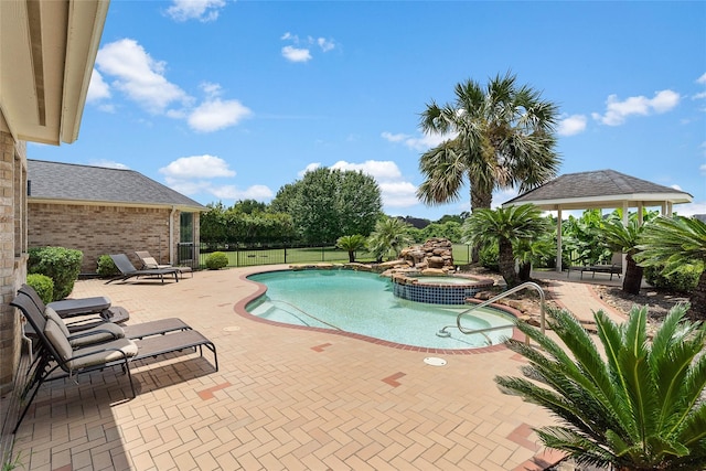 view of swimming pool featuring a gazebo, a patio area, and an in ground hot tub