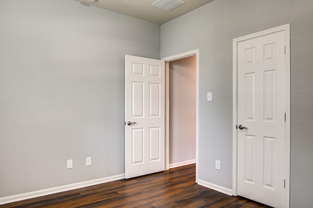 empty room featuring dark hardwood / wood-style flooring