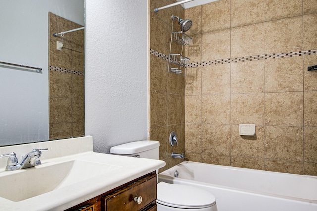 full bathroom with tiled shower / bath, vanity, and toilet