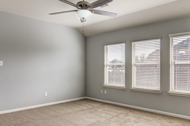 unfurnished room featuring ceiling fan, light colored carpet, and vaulted ceiling