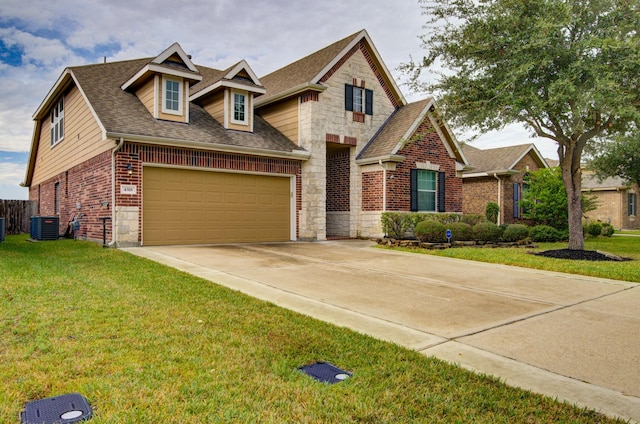 view of front of house featuring cooling unit, a garage, and a front yard