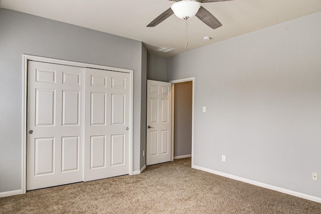 unfurnished bedroom with ceiling fan, light carpet, and a closet