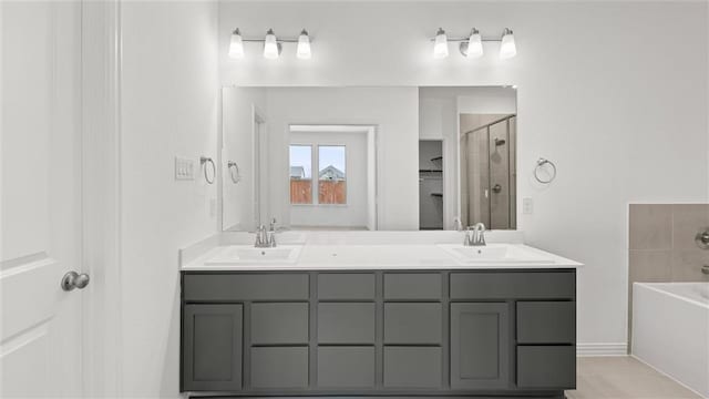 bathroom featuring shower with separate bathtub and vanity