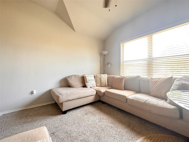 living room featuring ceiling fan, lofted ceiling, and carpet