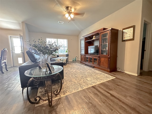 living room featuring lofted ceiling, a healthy amount of sunlight, dark hardwood / wood-style floors, and ceiling fan