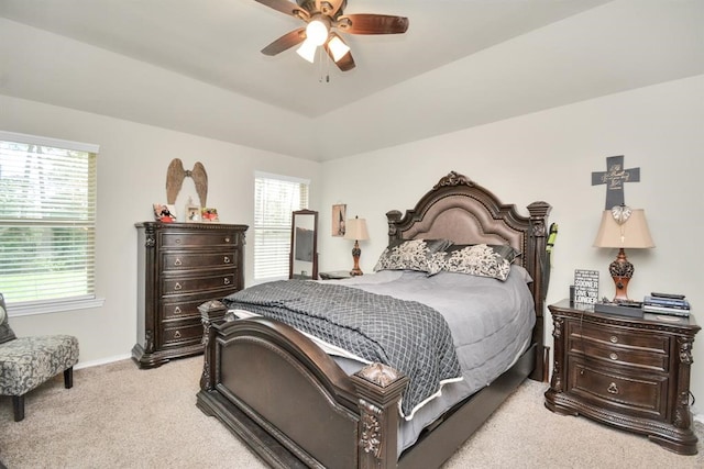 bedroom with vaulted ceiling, light colored carpet, and ceiling fan