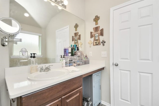 bathroom featuring vanity and vaulted ceiling