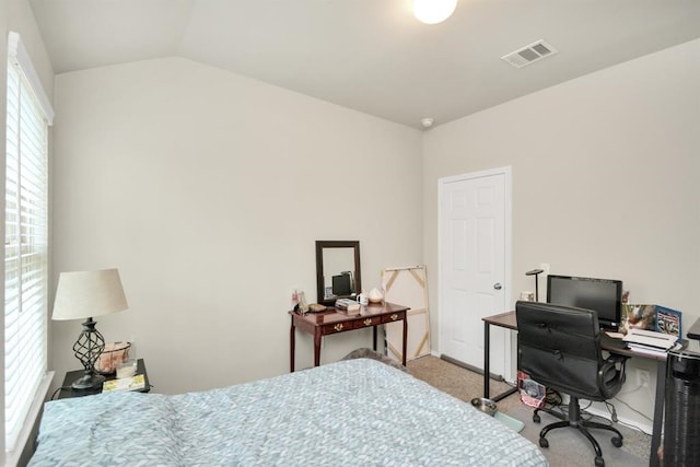 bedroom with lofted ceiling and light carpet