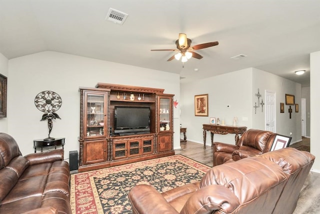 living room featuring lofted ceiling, wood-type flooring, and ceiling fan