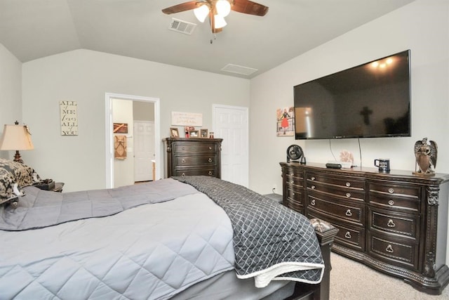 carpeted bedroom with ceiling fan, connected bathroom, and vaulted ceiling