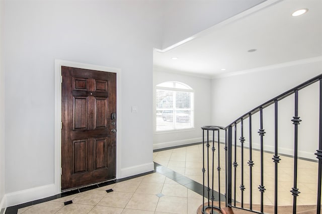 entryway featuring light tile patterned floors and ornamental molding