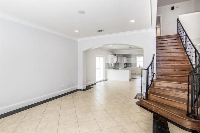 tiled foyer entrance with ornamental molding