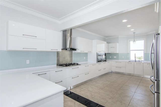 kitchen with backsplash, white cabinetry, wall chimney range hood, and stainless steel appliances