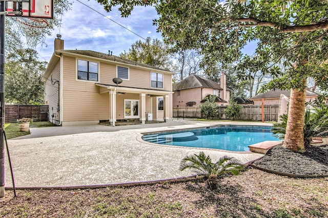 view of swimming pool featuring ceiling fan and a patio area