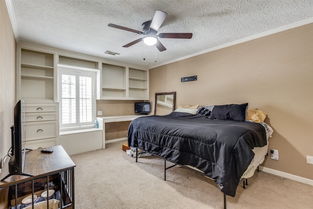 bedroom with a textured ceiling, light carpet, ceiling fan, and crown molding