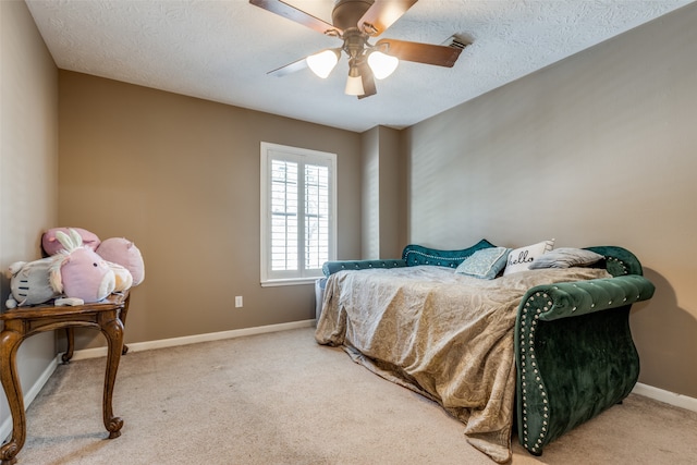 carpeted bedroom with a textured ceiling and ceiling fan