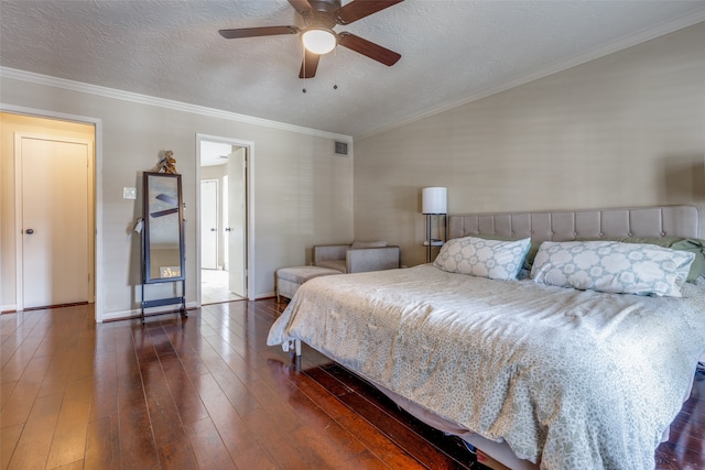 bedroom featuring ceiling fan, a textured ceiling, dark hardwood / wood-style flooring, and crown molding