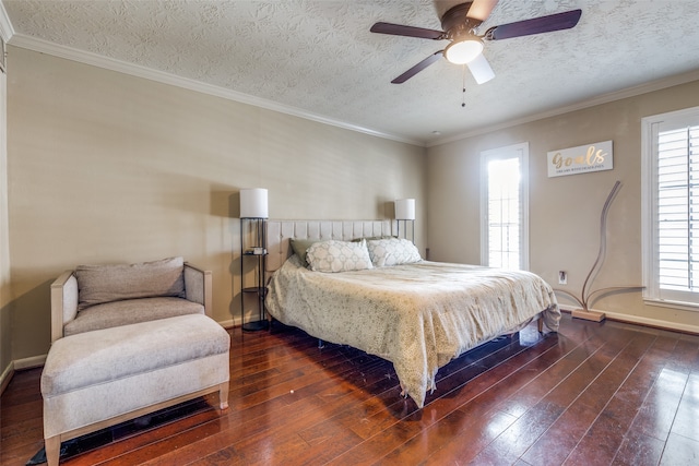 bedroom featuring ornamental molding, dark wood-type flooring, a textured ceiling, and ceiling fan