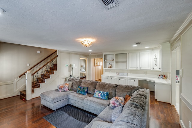 living room featuring ornamental molding, a textured ceiling, and dark hardwood / wood-style floors