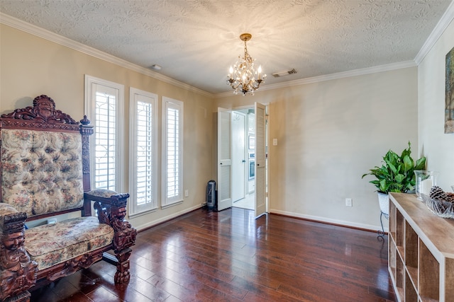 interior space featuring a textured ceiling, ornamental molding, dark hardwood / wood-style floors, and a notable chandelier