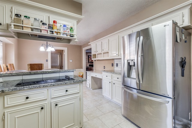 kitchen with pendant lighting, light tile patterned floors, white cabinetry, black electric cooktop, and stainless steel fridge with ice dispenser