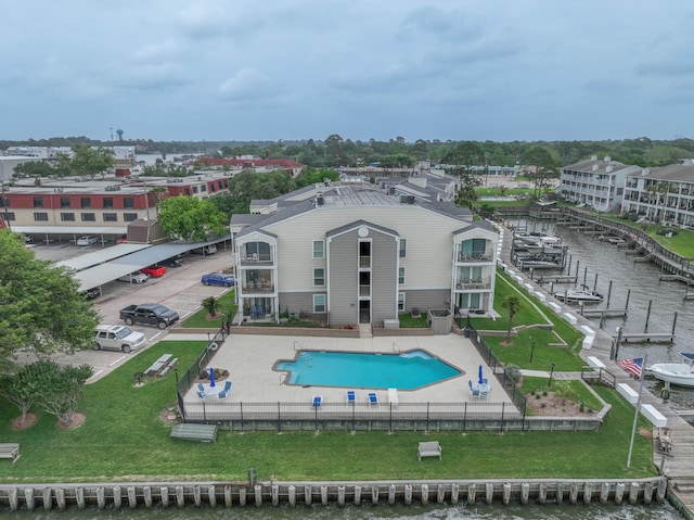 view of swimming pool featuring a water view and a patio area