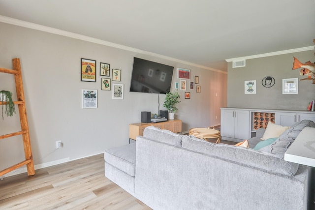 living room featuring light hardwood / wood-style floors and crown molding