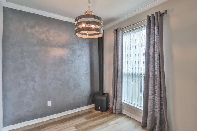 114 Yacht Club Ln Unit 114, El Lago, TX 77586 - empty room featuring wood finished floors, ornamental molding, a chandelier, and baseboards