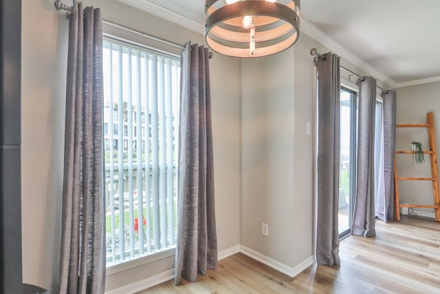 foyer with light wood-type flooring and crown molding