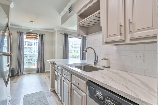 kitchen with sink, appliances with stainless steel finishes, light hardwood / wood-style flooring, crown molding, and decorative backsplash