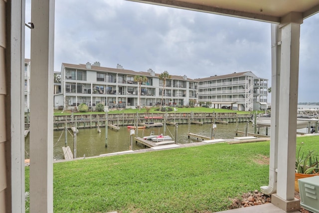 view of dock featuring a water view and a lawn